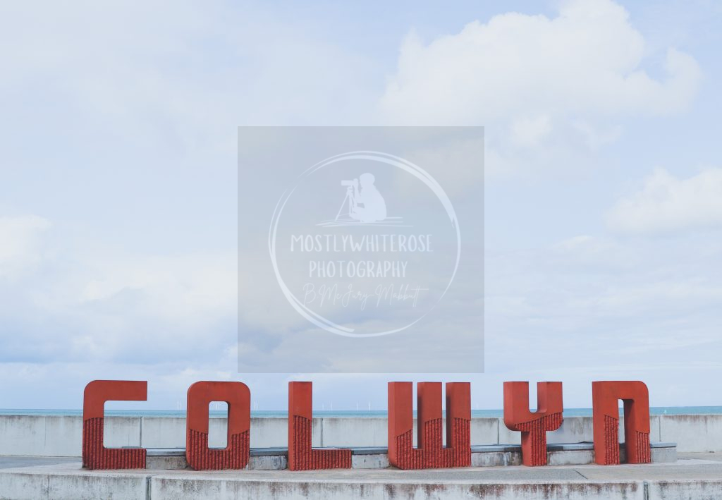 Colwyn sculpture seafront beachfront letters blue sea and white wind turbines