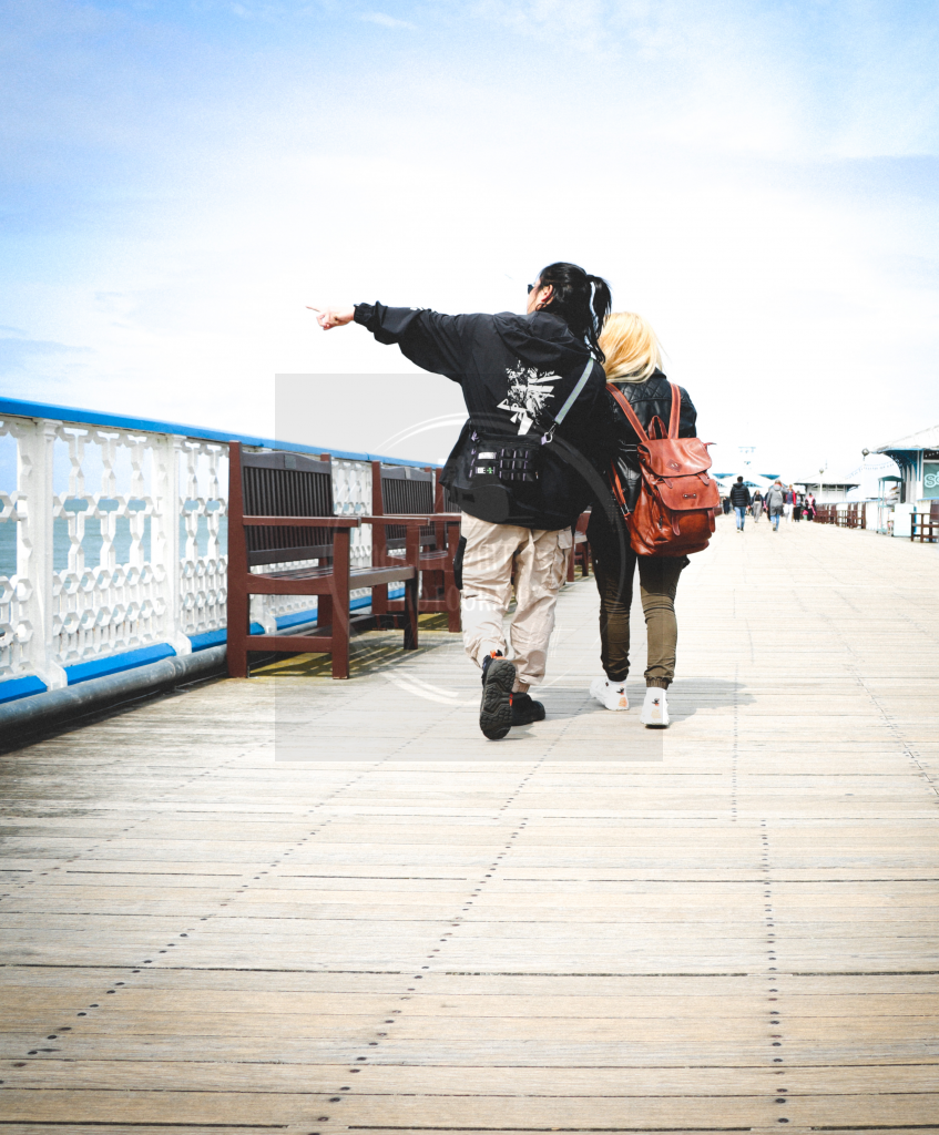 sightseeing stylish couple Llandudno pier sunglasses backpacks love